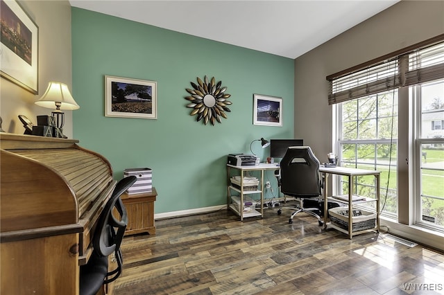 office area with dark wood-type flooring and baseboards