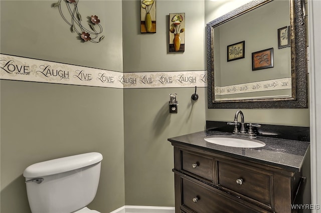 half bathroom with vanity and toilet