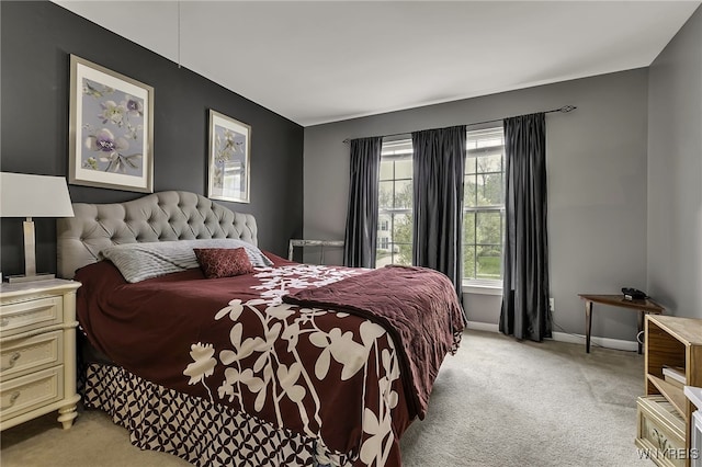 bedroom with light carpet and baseboards