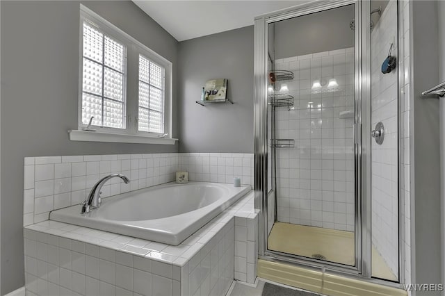 full bath with a stall shower and a bath