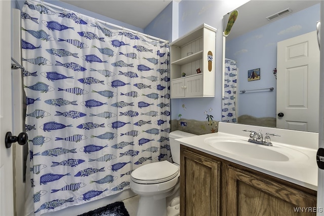 full bathroom featuring toilet, vanity, and curtained shower