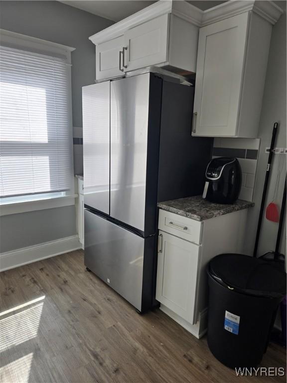 321 Hamilton Blvd, Tonawanda-Town, NY 14217 - kitchen featuring light wood finished floors, white cabinets, freestanding refrigerator, and baseboards