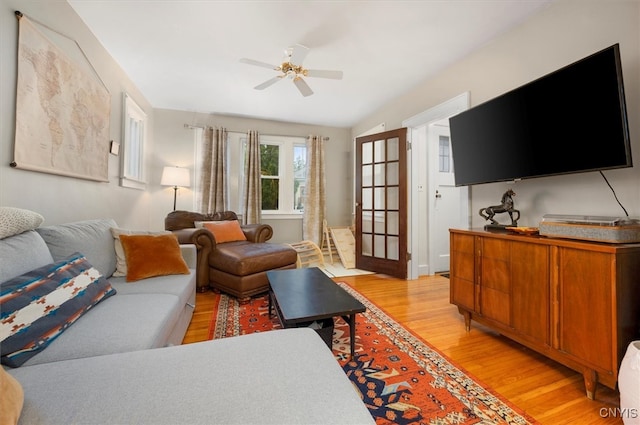 living room featuring light wood-style flooring and ceiling fan