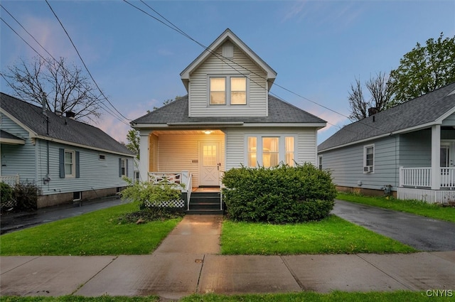 view of front of house with a porch and a front lawn