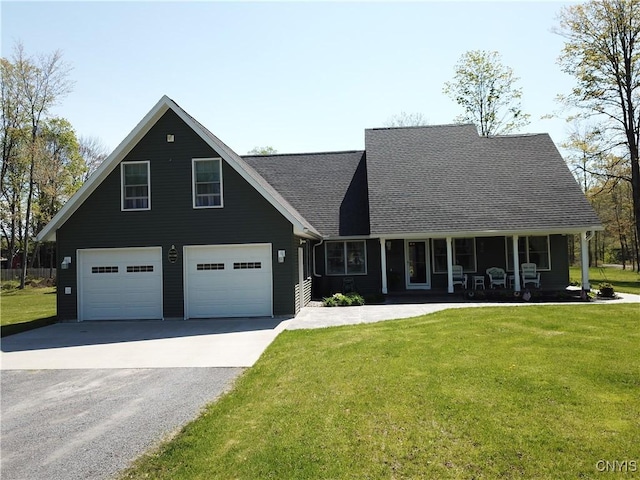 view of front facade with a front yard, asphalt driveway, a garage, and roof with shingles