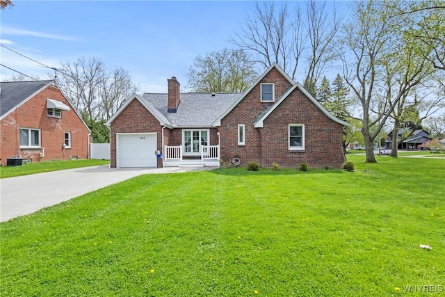 view of front of home with a chimney, a front yard, brick siding, a garage, and driveway
