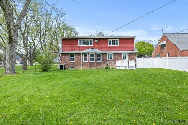 back of house with brick siding and central AC unit