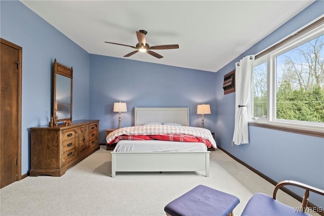 carpeted bedroom featuring baseboards and ceiling fan