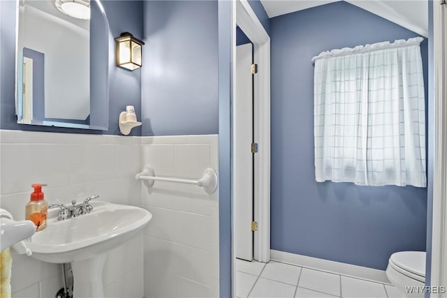bathroom with toilet, tile patterned floors, and a sink
