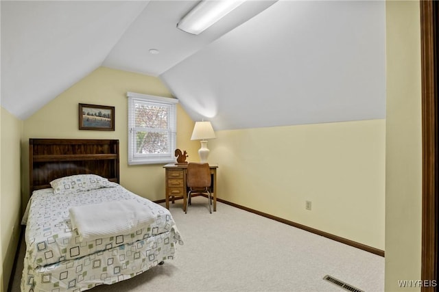bedroom with lofted ceiling, carpet, and baseboards