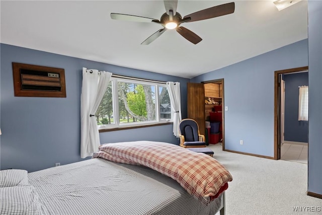 carpeted bedroom with vaulted ceiling, baseboards, and a ceiling fan