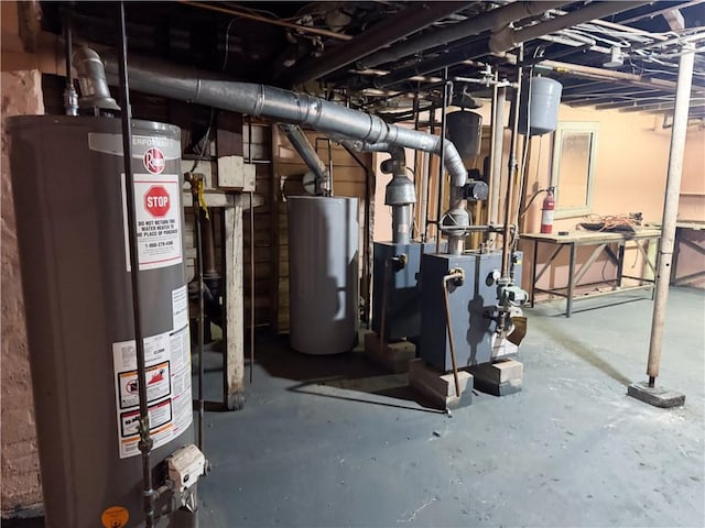 utility room with water heater and a heating unit