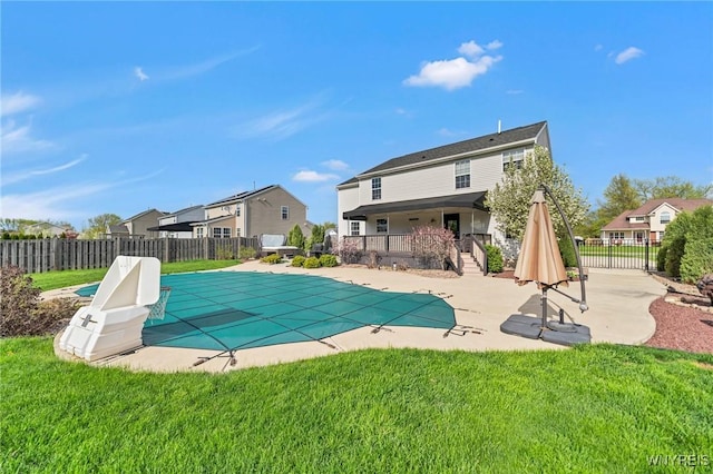 view of swimming pool with a patio and a residential view