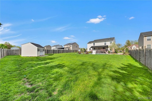 view of yard featuring an outbuilding and a residential view