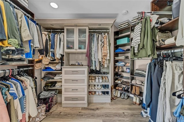 walk in closet with light wood-type flooring