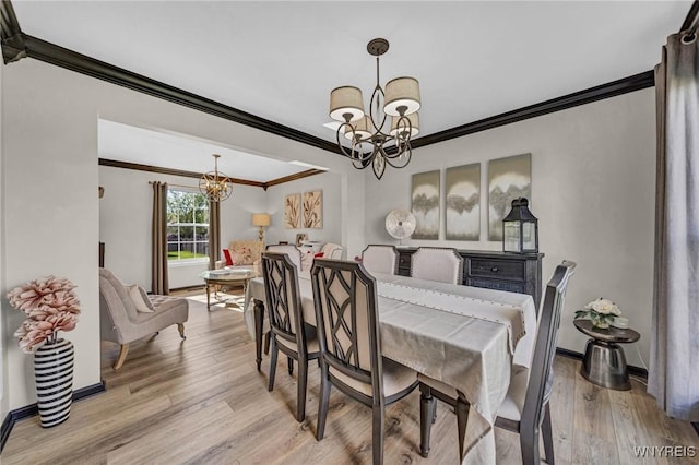 dining space with a chandelier, ornamental molding, light wood-type flooring, and baseboards