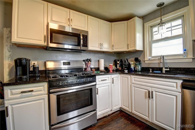 226 Parkhurst Blvd, Tonawanda-Town, NY 14223 - kitchen with appliances with stainless steel finishes, a sink, dark wood-type flooring, white cabinetry, and decorative light fixtures
