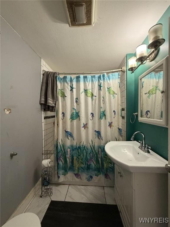 226 Parkhurst Blvd, Tonawanda-Town, NY 14223 - full bathroom featuring marble look tiles, curtained shower, vanity, and toilet