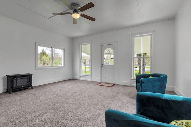 6043 Old Niagara Rd, Lockport Town, NY 14094 - carpeted foyer featuring a wood stove, plenty of natural light, ceiling fan, and baseboards