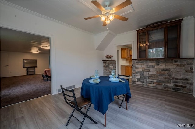 6043 Old Niagara Rd, Lockport Town, NY 14094 - dining room with wood finished floors, ornamental molding, ceiling fan, a fireplace, and baseboards