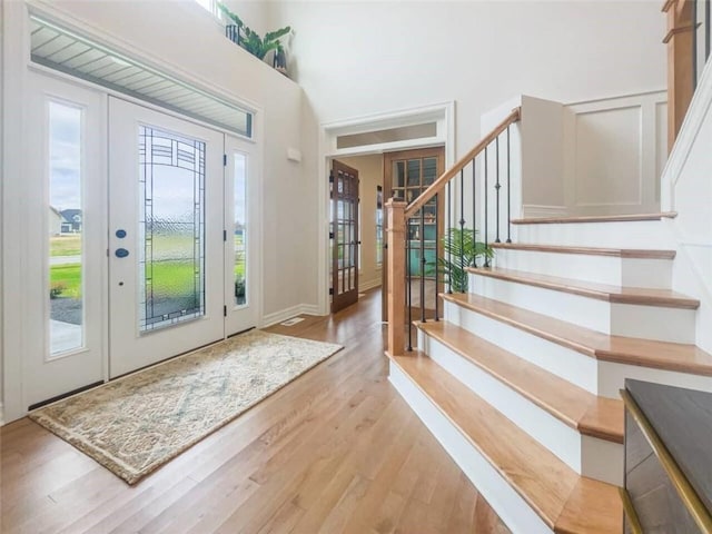 160 Jade Creek Dr, Greece, NY 14468 - entryway featuring french doors, light wood-style flooring, stairs, and a high ceiling