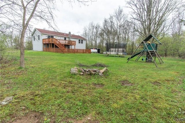 30204 County Route 179, Lyme, NY 13622 - view of green lawn featuring a trampoline, a playground, and a deck
