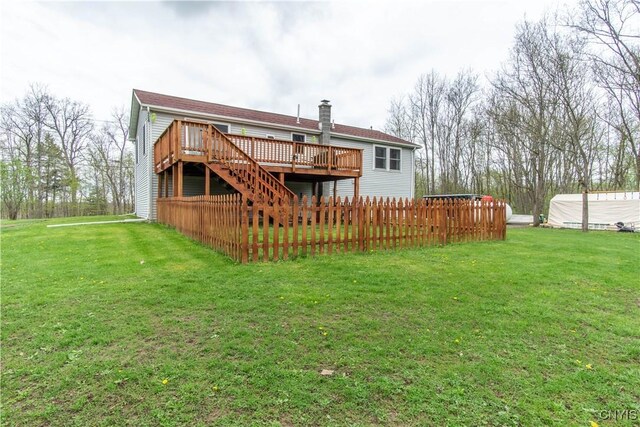 30204 County Route 179, Lyme, NY 13622 - back of property featuring a wooden deck, a yard, stairway, and a chimney