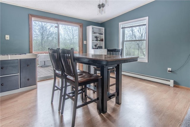 30204 County Route 179, Lyme, NY 13622 - dining space featuring a baseboard radiator, plenty of natural light, wood finished floors, a textured ceiling, and ornamental molding