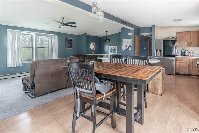 30204 County Route 179, Lyme, NY 13622 - dining room with baseboard heating, light wood-type flooring, a ceiling fan, and vaulted ceiling