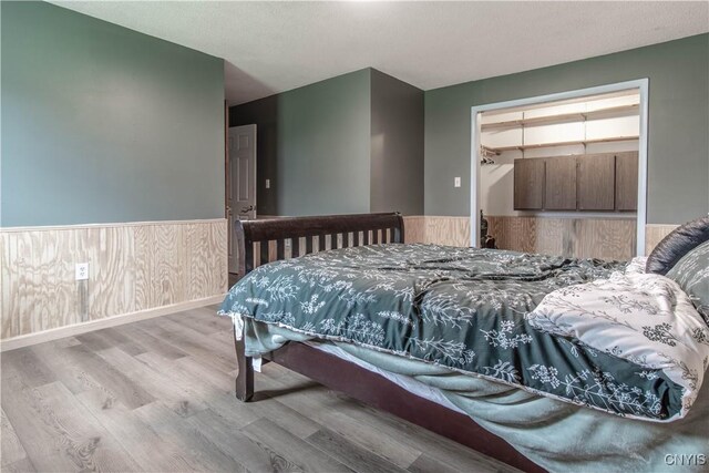 30204 County Route 179, Lyme, NY 13622 - bedroom with wainscoting and wood finished floors