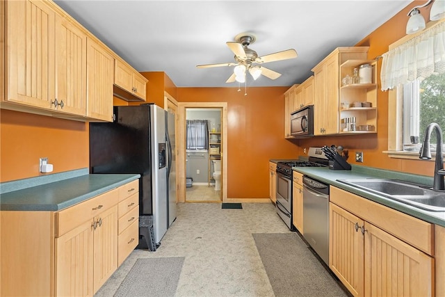kitchen with appliances with stainless steel finishes, light brown cabinetry, a sink, and ceiling fan