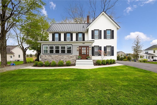 469 Salt Rd, Webster, NY 14580 - modern farmhouse with a front lawn, a chimney, metal roof, stone siding, and a standing seam roof