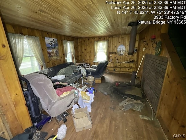 sitting room with wood finished floors, wooden walls, and wood ceiling