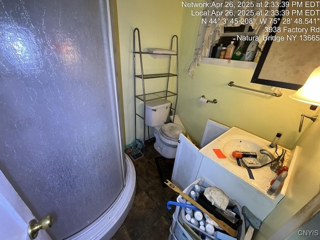 bathroom with a stall shower and toilet