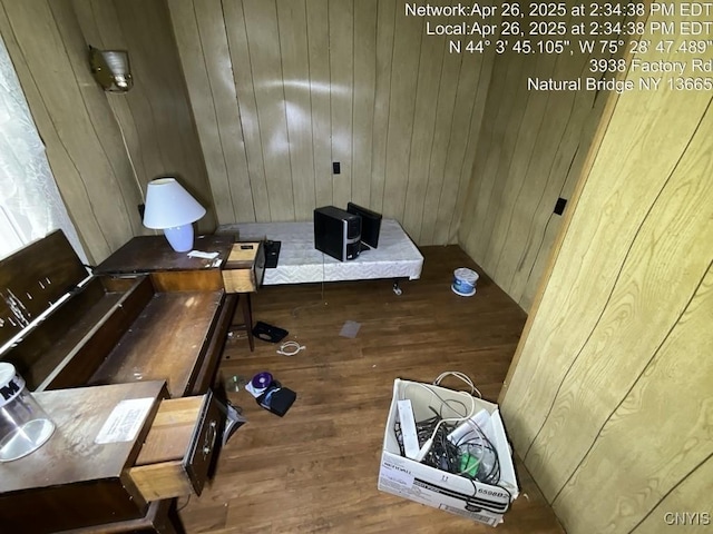 misc room with wood finished floors and wooden walls