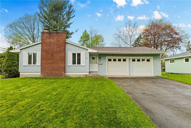 view of front of house with asphalt driveway, a garage, a chimney, and a front lawn