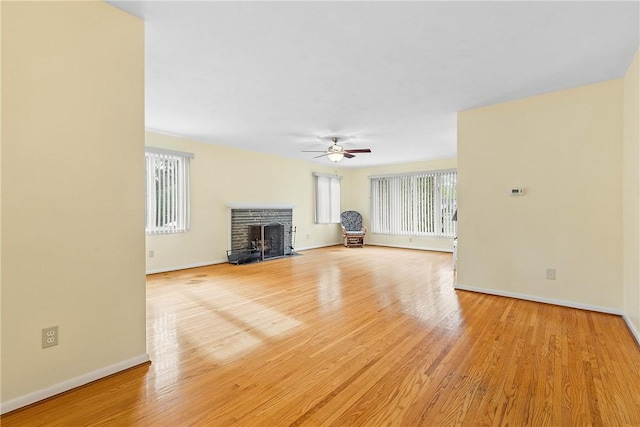unfurnished living room featuring healthy amount of natural light and baseboards
