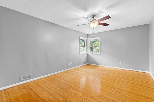 unfurnished room with wood finished floors, ceiling fan, and baseboards