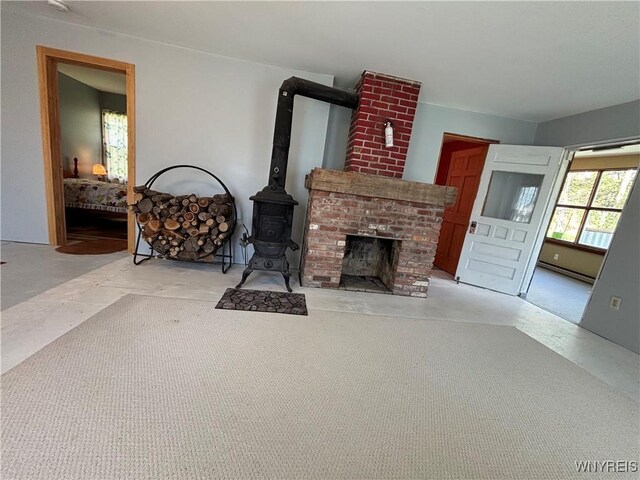 living room with a brick fireplace and baseboard heating