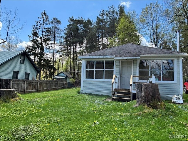 back of house with a shingled roof