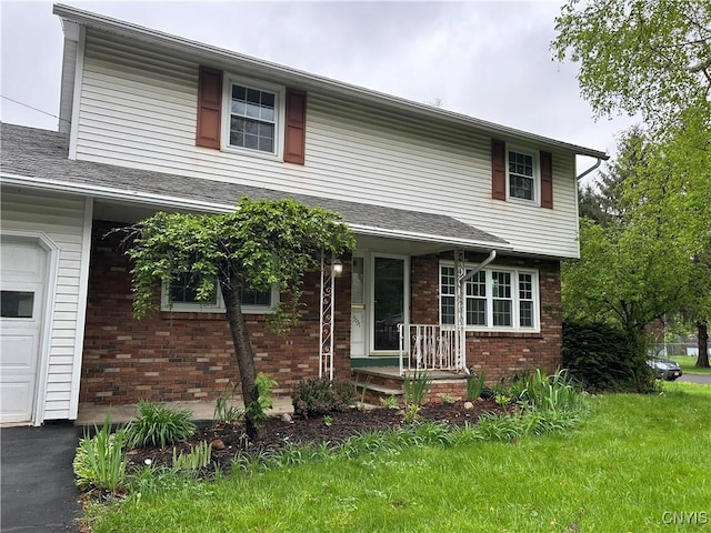 5131 Bear Rd, Clay, NY 13212 - traditional home featuring brick siding, a front lawn, and a garage