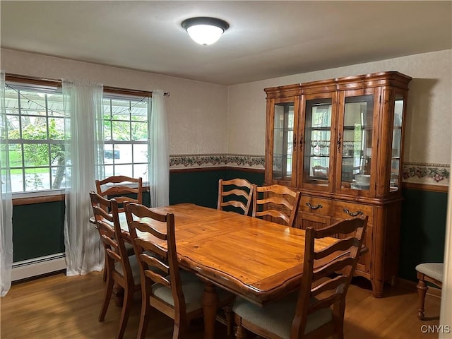 5131 Bear Rd, Clay, NY 13212 - dining space with wood finished floors, a baseboard radiator, and wainscoting
