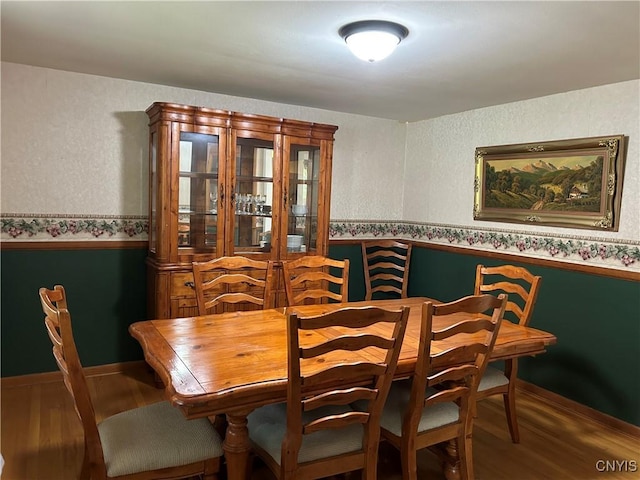 5131 Bear Rd, Clay, NY 13212 - dining space featuring wood finished floors, wallpapered walls, and wainscoting