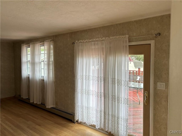 5131 Bear Rd, Clay, NY 13212 - spare room with a baseboard heating unit, light wood-type flooring, and a textured ceiling