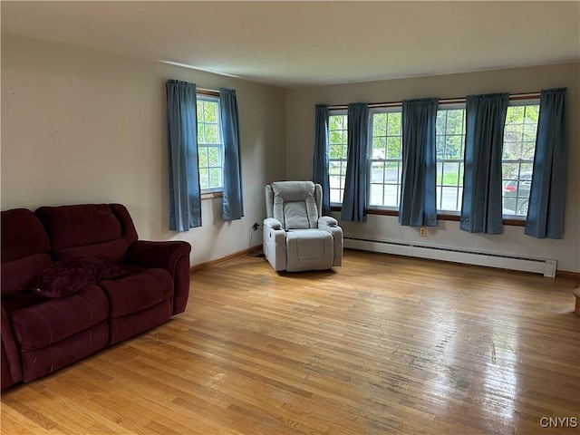 5131 Bear Rd, Clay, NY 13212 - living area featuring baseboard heating, light wood-style floors, and baseboards