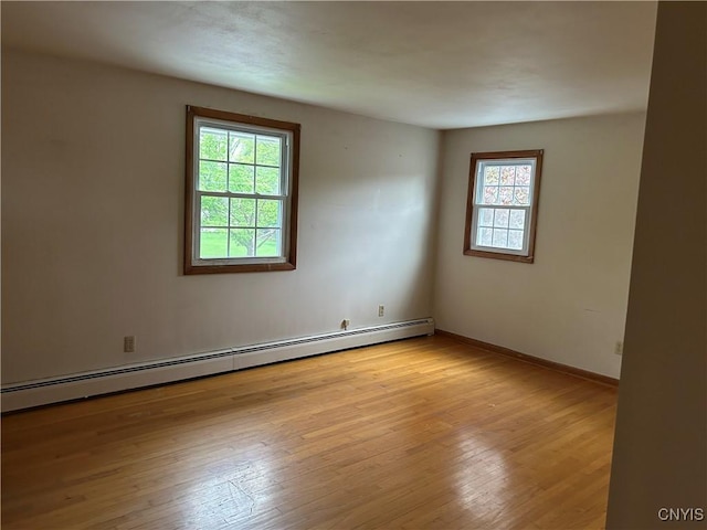 5131 Bear Rd, Clay, NY 13212 - unfurnished room featuring a baseboard radiator, light wood-type flooring, and baseboards