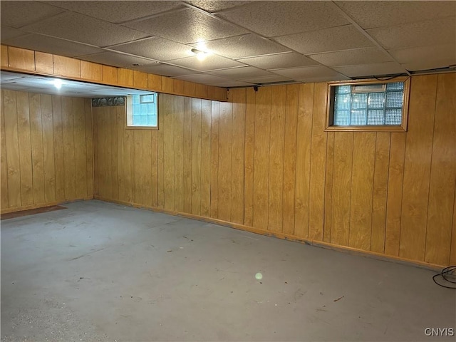5131 Bear Rd, Clay, NY 13212 - basement featuring baseboards, a drop ceiling, and wood walls