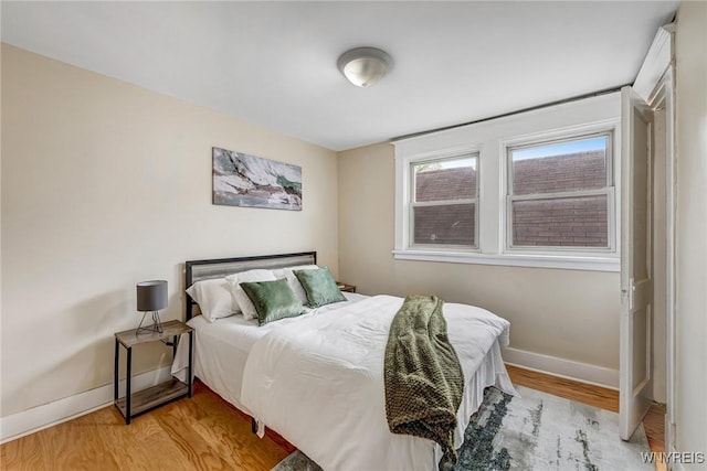 bedroom featuring baseboards and light wood-type flooring