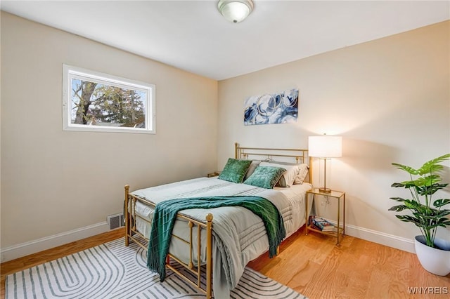 bedroom featuring baseboards and wood finished floors