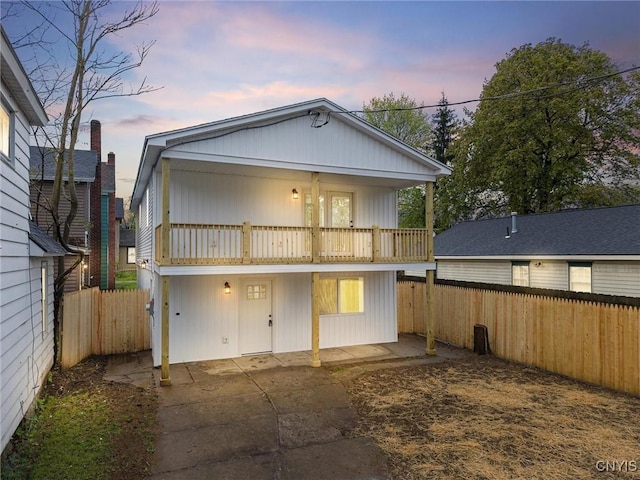 614 E Broadway St, Fulton, NY 13069 - back of property with a balcony, a fenced backyard, and a patio